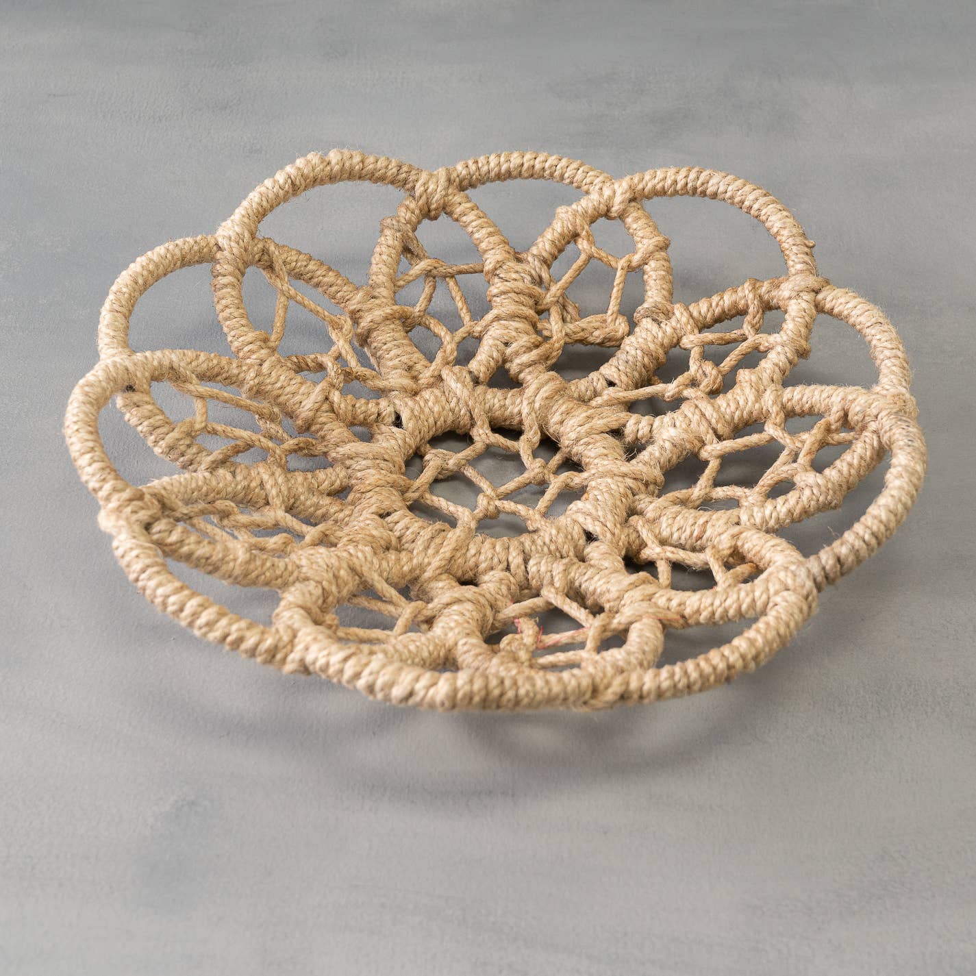 Natural jute wall basket wrapped over an iron base. Structured boho wall decor ideal for layered walls, entryway storage, and modern interiors.