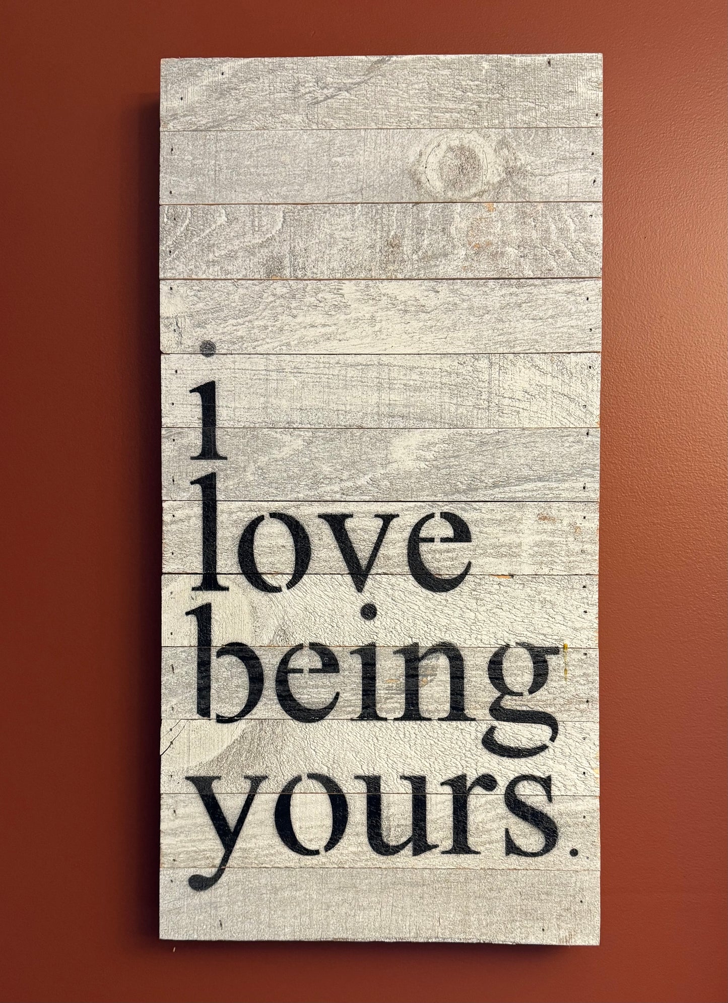 A beautiful reclaimed wood sign that says I love being yours